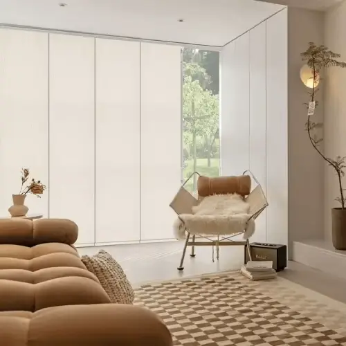 Modern white panel track blinds installed on a large sliding glass patio door in a home.
